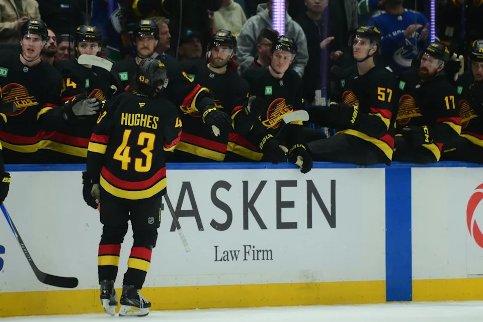 Nov 23, 2025; Vancouver, British Columbia, CAN; Vancouver Canucks defenseman Quinn Hughes (43) celebrates scoring with teammates on the bench during the third period against the Calgary Flames at Rogers Arena. Mandatory Credit: Simon Fearn-Imagn Images