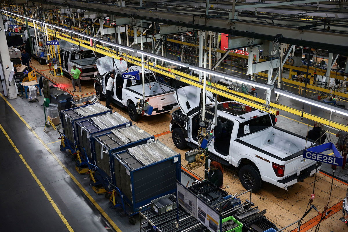 Evelyn Hockstein/Reuters via CNN NewsourceEmployees work at an auto production center in Dearborn