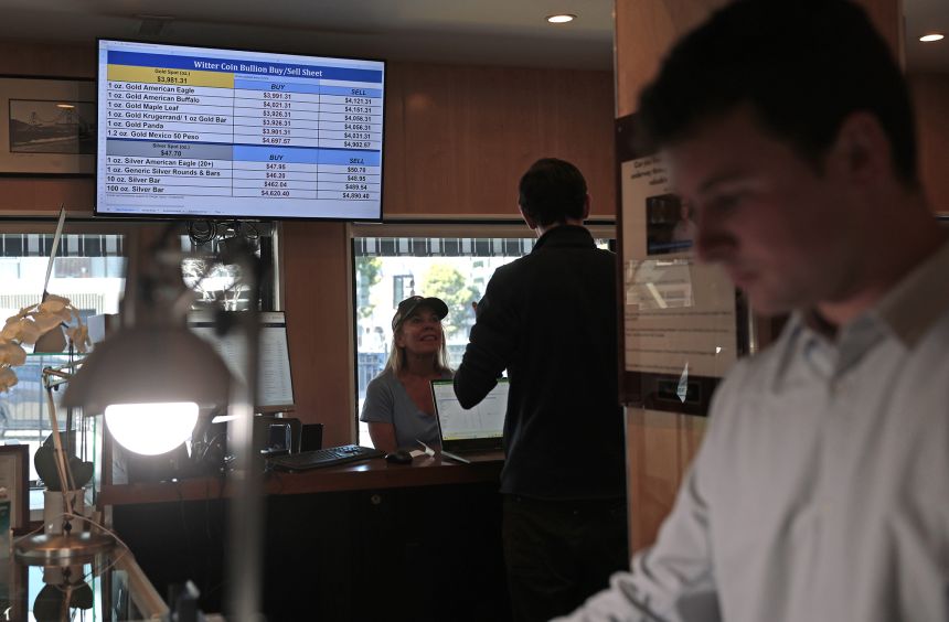 Gold prices are displayed on a monitor at Witter Coins on October 7, 2025, in San Francisco, California. The cost of gold crossed $5,000 per ounce this past week.