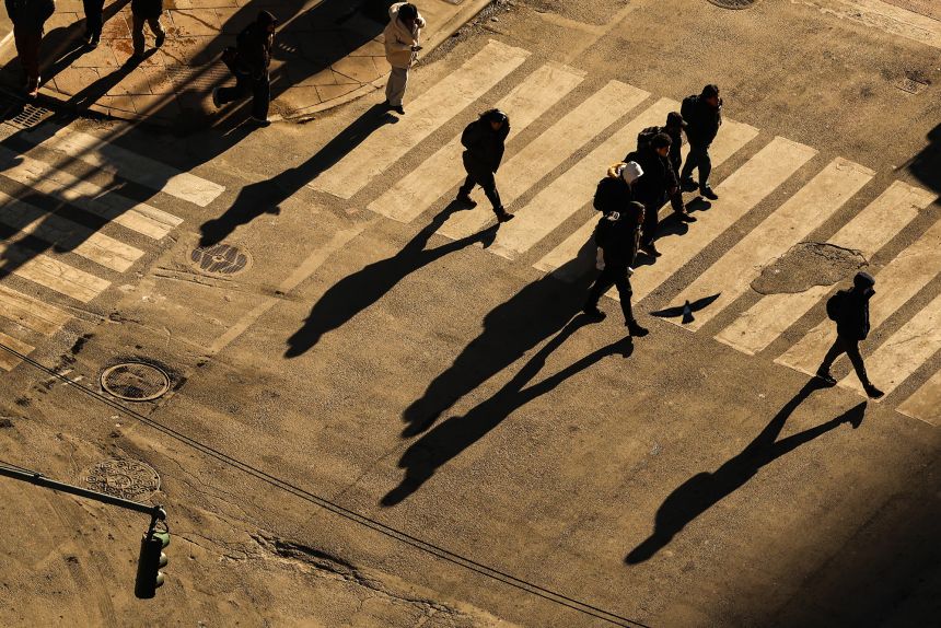 Pedestrians move along Lexington Avenue in the Manhattan borough of New York City on December 16, 2025.