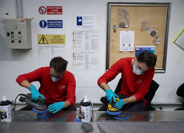 Employees work on medals for the Milano-Cortina Winter Paralympics at the Italian Mint in December 2025.