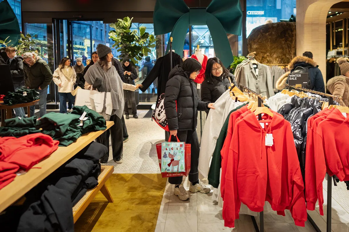 Americans kept their shopping flat in December, as wage growth cooled