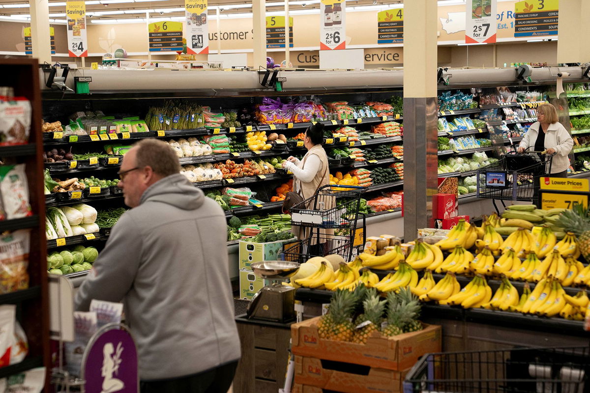 David Ryder/Reuters via CNN NewsourceFood shoppers browse for groceries ahead of the Thanksgiving Day holiday at an Albertsons supermarket in Redmond