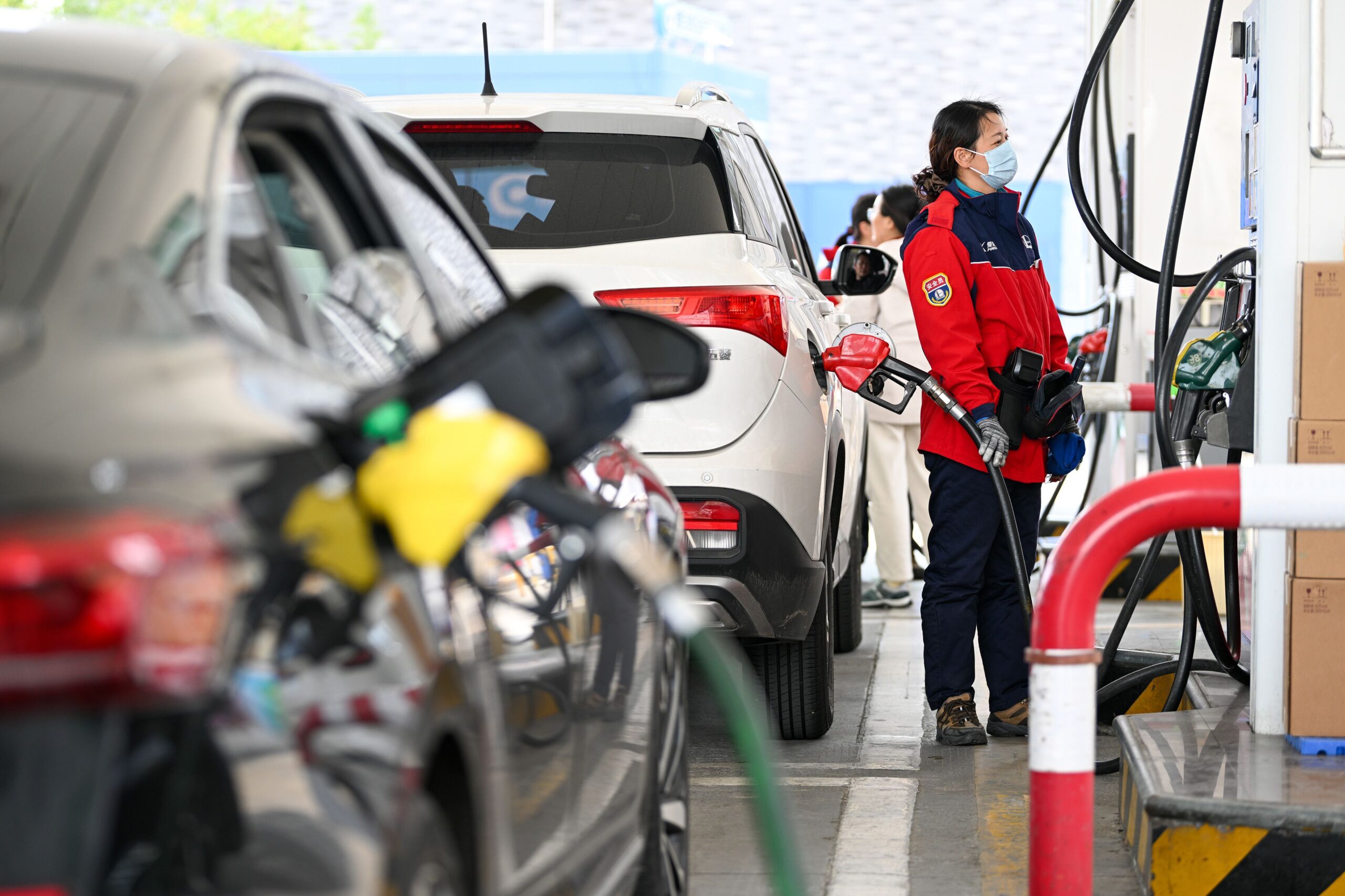 Fang Dongxu/FeatureChina/AP via CNN NewsourceA worker refills a car at a gas station in Nanjing in eastern China on March 9