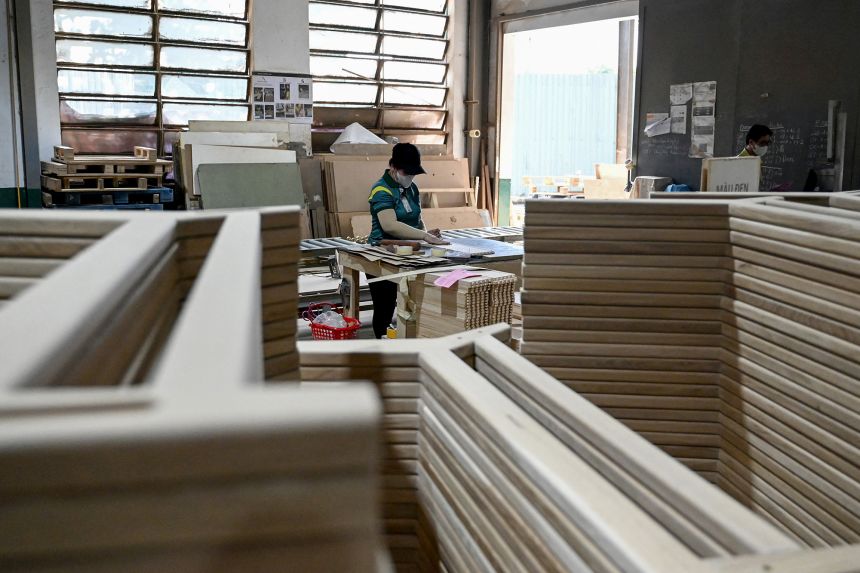 This photo taken on November 4, 2025, shows an employee working inside a furniture factory in Ho Chi Minh City, Vietnam.