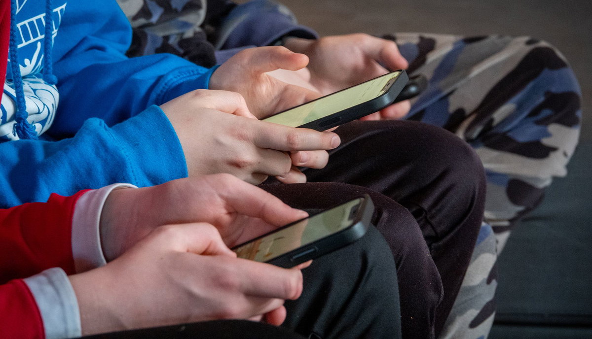Matt Cardy/Getty Images via CNN NewsourceTeenage boys look at their smartphones in a village near Morzine