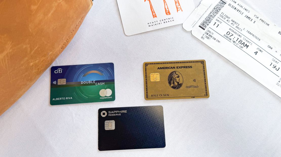 Three Citi, American Express and Chase credit cards on a table next to an airplane boarding pass