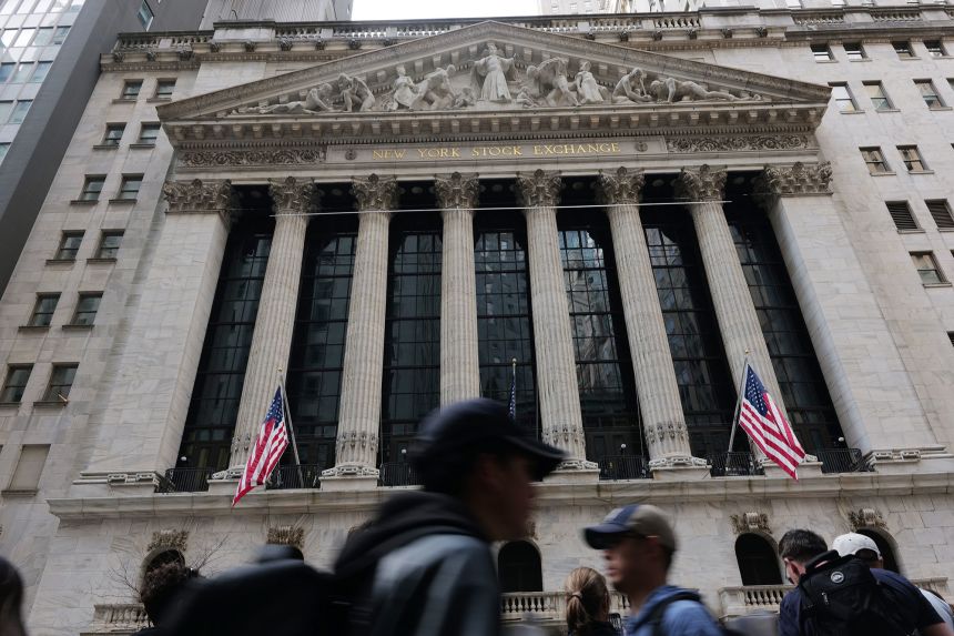 People walk outside the New York Stock Exchange.