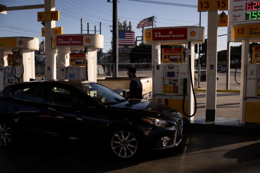People put gas in their cars at a Shell gas station located in front of the ConocoPhillips Oil Refinery in Wilmington, California on April 11, 2026.