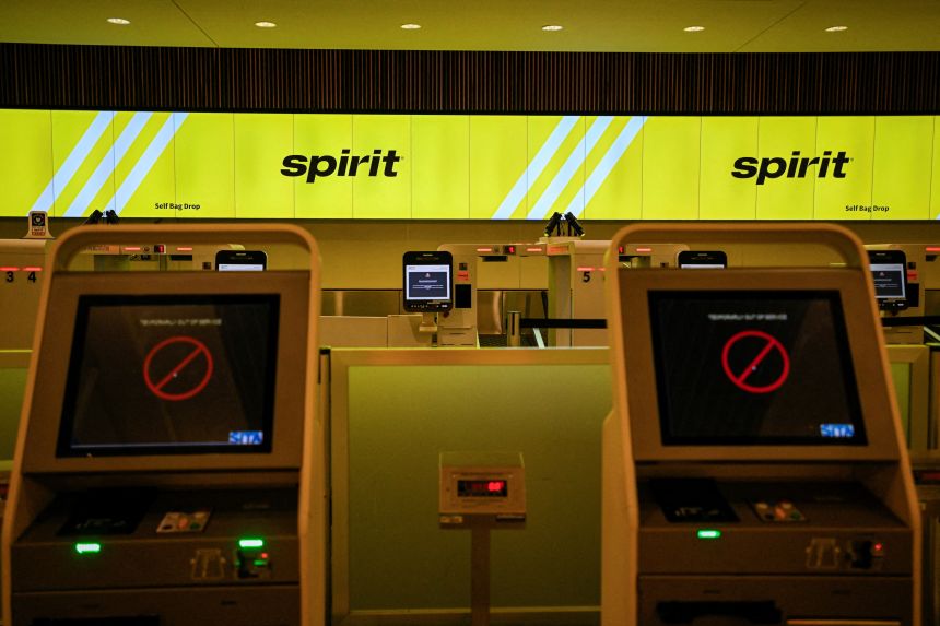 A Spirit Airlines bag dropoff counter at Orlando International Airport is shutdown after the airline halted all fights on Saturday.