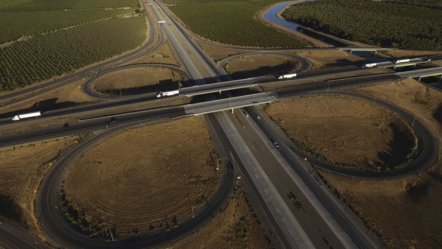 Freight trucks travel on Interstate 5 Highway in September 2025, in Tracy, California. Foreign-born truckers shape the industry, making up almost one in six CDL holders.