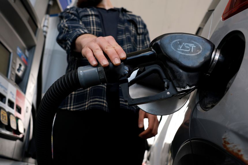 A customer pumps gas into his car at a gas station in Los Angeles.