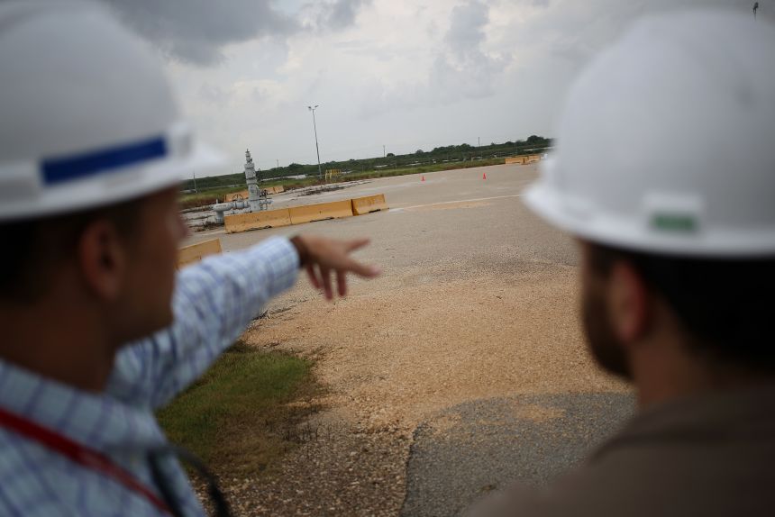 US Department of Energy personnel examine wellheads located on top of oil-filled subterranean salt caverns at the Bryan Mound Strategic Petroleum Reserve in Freeport, Texas, on June 9, 2016.