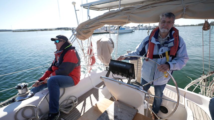 Martin Høgh Sørensen steers his boat in Kalundborg, Denmark while friend Michael Eliasen controls the sails.