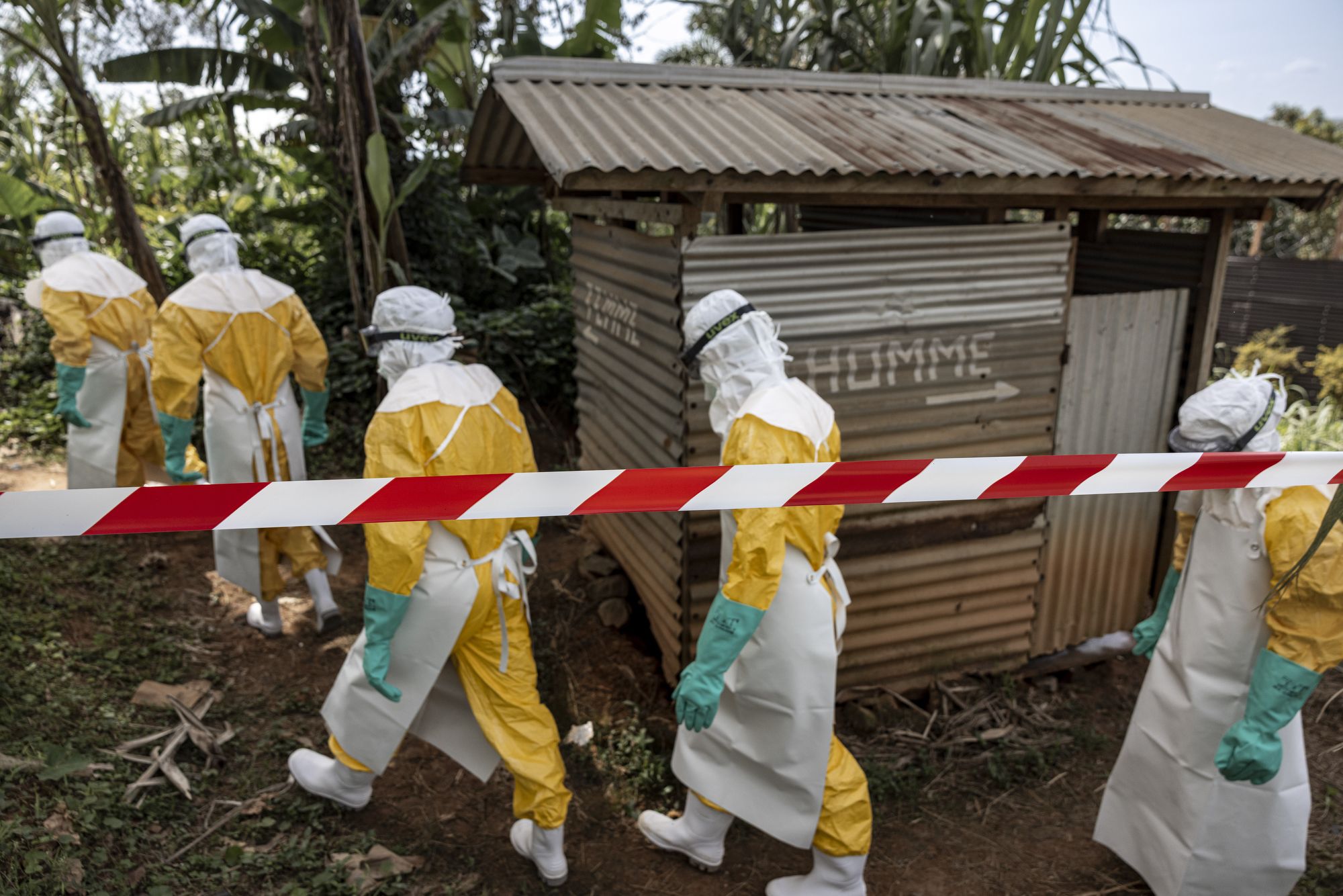 <i>Michel Lunanga/Getty Images via CNN Newsource</i><br/>MSF teams wearing full protective equipment reinforce perimeter barriers around a restricted Ebola isolation zone and basic hygiene facilities