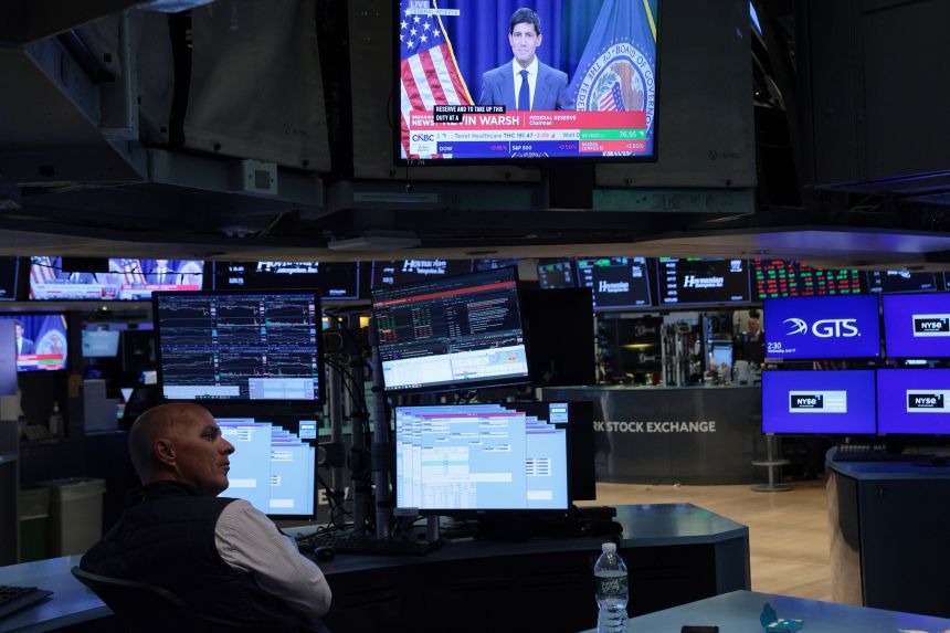 A TV shows Warsh on the floor of the New York Stock Exchange on Wednesday.